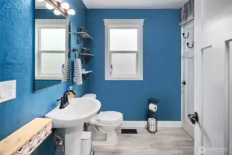 On your left, we have a bright and cheery bathroom with a frosted glass window for added privacy.