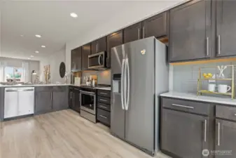 Ample cabinetry, electric range, and peninsula seating – a chef’s kitchen with style and function.