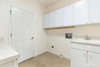 Laundry room and  garage entry - peep the full sized laundry sink!