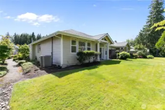 Exterior view of back of home - peep the walking path connecting front/back yards.