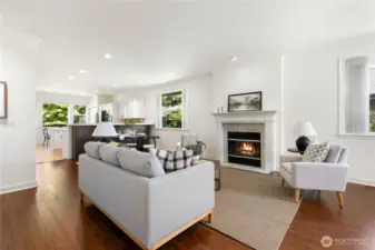 Large open, great room/family room complete with gas fire place and filled with warm natural light.