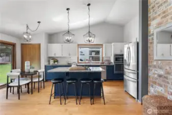 Granite-topped island with bar seating is the centerpiece of this modern kitchen.