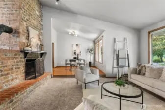 Cozy living room with soft carpet, perfect for relaxing. Enjoy the wood burning fireplace.
