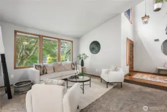 Huge windows with lush tree view and natural light flowing in during afternoon/evening hours.