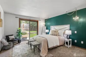 Spacious primary suite with a sliding door to backyard/patio.