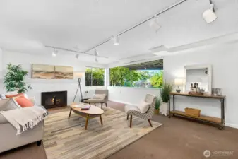 Generous lower level family room has wood burning fireplace and a view of the back yard.