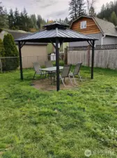 Gazebo with dining table and chairs