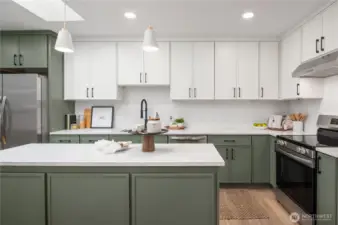Full height upper cabinets, pendant lights and even an overhead skylight make this a memorable kitchen.