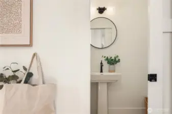 The powder room is one of 3 bathrooms and features a new pedestal sink and all new fixtures.