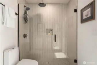 The oversized shower has an overhead rainfall shower head plus a fixed wall showerhead and finally, a handheld shower head.