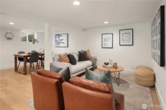 Downstairs is this rec room that is equally gorgeous with the same engineered wood floors, recessed lighting and new millwork.