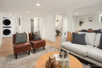 Looking across the L-shaped rec room you can see the third bedroom to the right and a new bathroom in the middle.