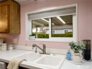 Do the dishes with the view of the large size side yard.