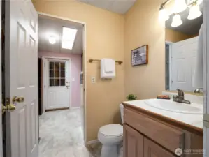 You have access to the second bathroom both from the front hallway and thd the laundry room.