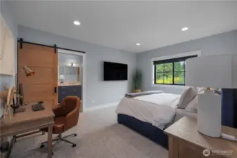 Primary Suite with barn door into the bath area. Custom blinds and cozy carpet!