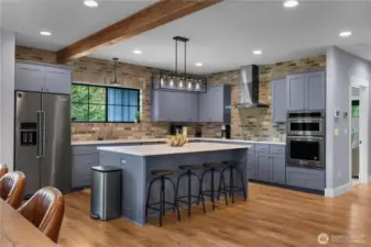 Kitchen has Honed Quartz counters, beautiful cabinets and window looking out at the beach pine.