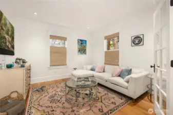 Den off dining area features french doors and fir wood floors.