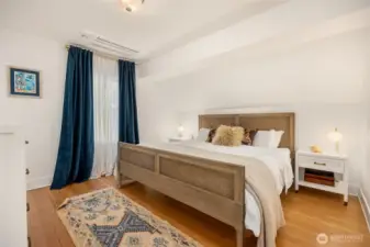 Luxurious primary bedroom with ensuite bath and walk-in closet feel like a premium boutique hotel room.