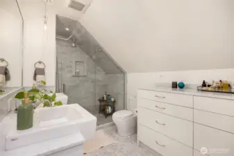 Built-in dresser with marble top to the right provides extra storage.