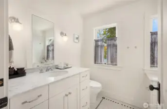 Second bathroom upstairs features period lighting and in-floor heating.