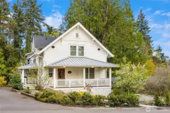 Home features beautiful landscaping and raised veggie beds (shown to the right of the house).