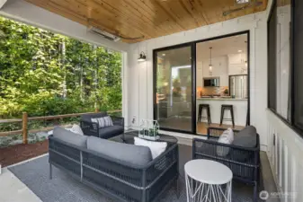 Covered back patio with forest backdrop.