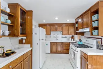 The kitchen features lots of cabinet space, a double sink and a new vented hood.