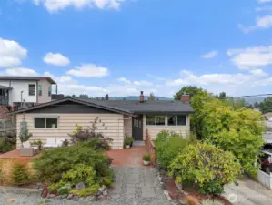 Welcome to this incredible Mid-Century Stunner!   The front of the home features a lovely large deck to welcome you.