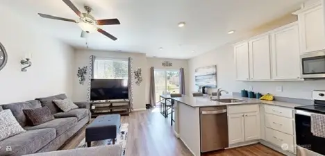 View from hallway of living room and kitchen