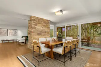 The fireplace grounds the dining area with its rich, textured presence.