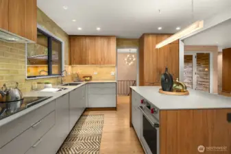 The lighting compliments the 'glazed in place' custom tile backsplash.