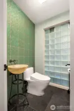 Powder room adorned with Ann Saks Chinois style tile.