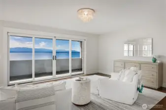 Lounge area in primary bedroom with private balcony.