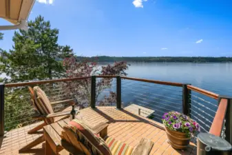The primary suite boasts its own private deck with commanding  panoramic lake views.