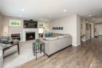 Sunny family room with built in storage and gas fireplace.