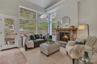 Cozy gas fireplace and wooden mantle make this a great spot year around to cozy in!  Note corner windows!