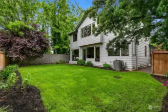 Back yard is level with great mature growth. *Photo taken in late Spring.