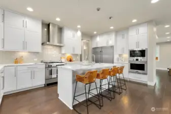 Chef's kitchen features high-end appliances, great workspace + ample storage.