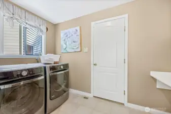 Utility/mud room with tile floors and custom cabinets