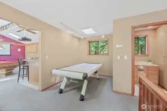 Detached game room and bathroom with shower, sink, and toilet