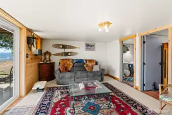 Basement suite living area with tongue and groove pine accent wall.