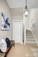 Stairway at the entry, leading to the second floor.