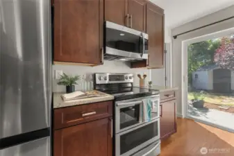 Quartz countertops and oven with optional double-oven feature and convection microwave.