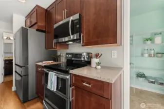 New Samsung fridge.  New cabinets have upgraded storage features including spice rack organizers.