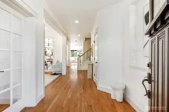 Beautiful double doors entryway, genuine hardwood flooring, home office bedroom on main off to the left with glass pane French doors.