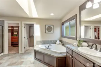 Primary ensuite, with soaking tub, separate shower, and separate vanities.