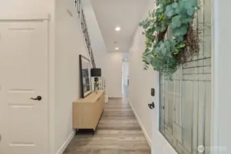 The entryway is covered and has ample space for outdoor seating in front as well as space inside for seating, shoes, and a large coat closet for storage.