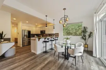 The dining and kitchen, showing the tech desk to the left and the slider to the backyard to the right.