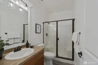 The main level bathroom with shower, making this "wing" the perfect guest suite or bedroom for anyone who might have trouble tackling the stairs.