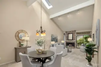 The dining and living rooms flow together, featuring vaulted ceilings with skylights and clerestory windows.